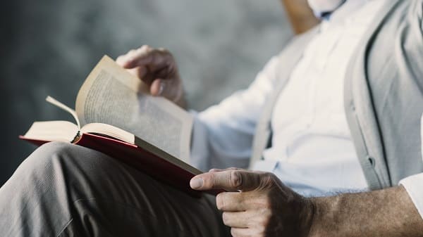 A man turning the pages of book