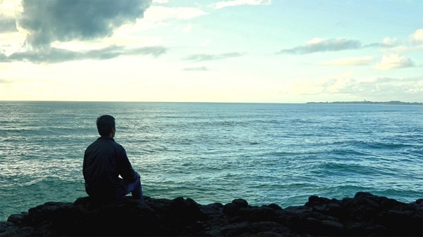 a man looking at the sea
