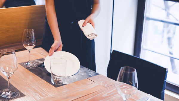 a waitress putting plate on table