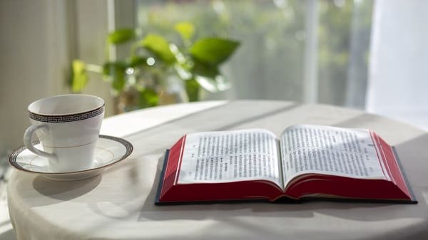 The bible book and the coffee mug on the table