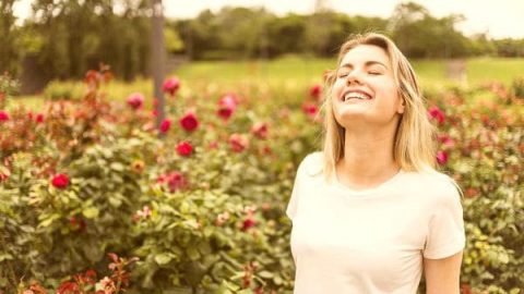 Beautiful woman enjoying the air in the garden