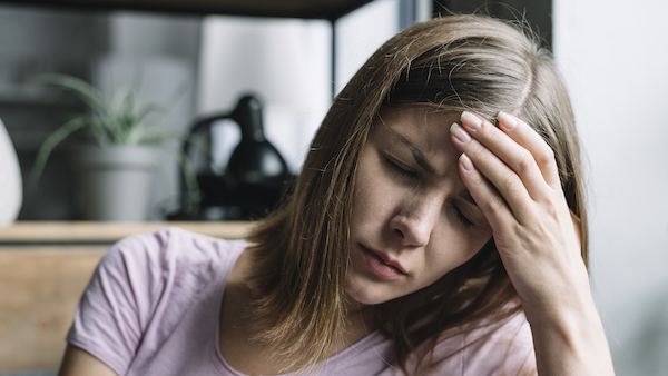 Painful woman frowning