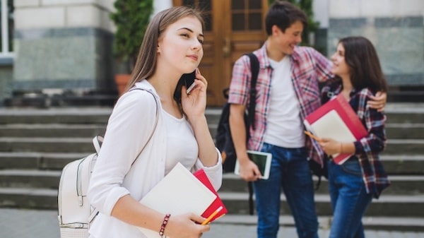 Girl talking phone near college