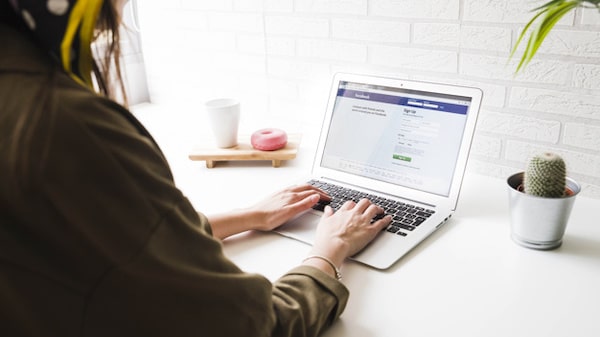 A woman is browsing the Facebook page
